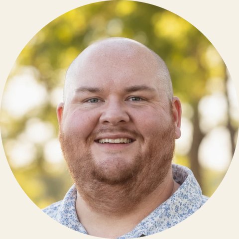 Matt LaFleur, smiling, outdoors with trees behind him